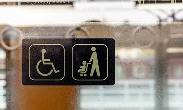 disabled passenger and parent child priority sticker on window of public transport 